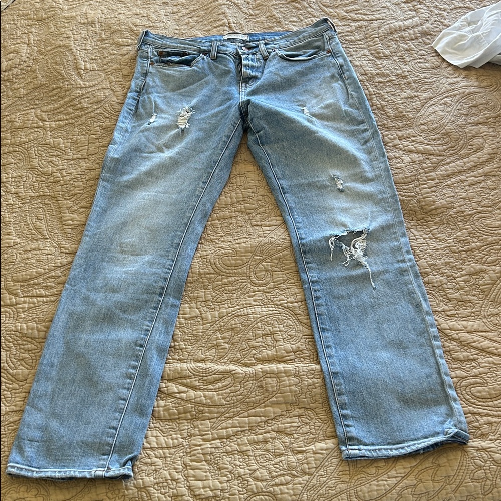 Madewell Slim Boy Jean, pale blue denim wash with rip details.